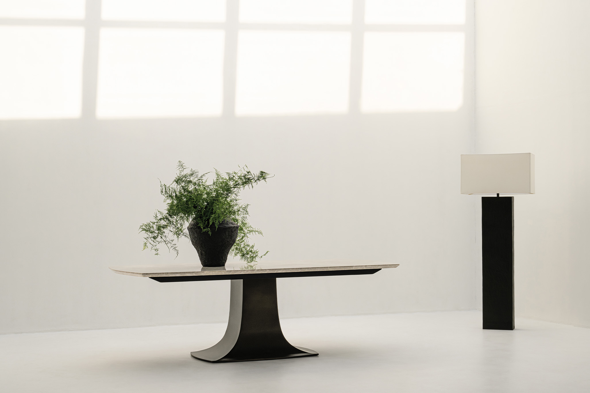 The dark lines tracing the lamp and table bases read like calligraphic strokes